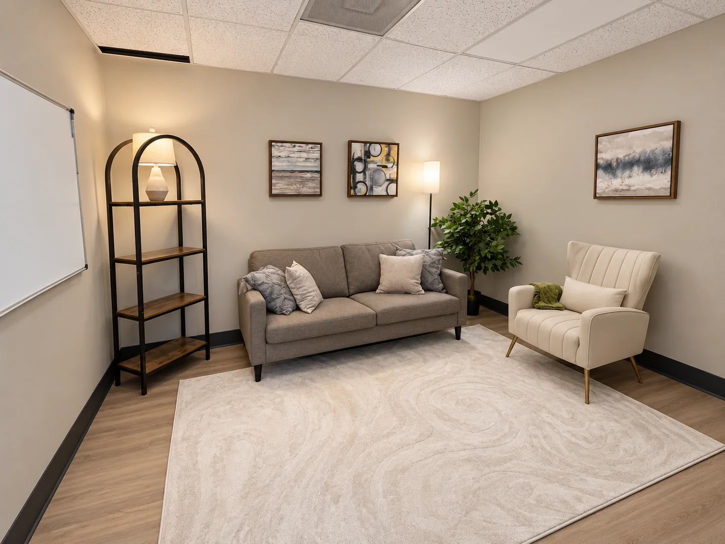Therapy room with a gray sofa and cream chair